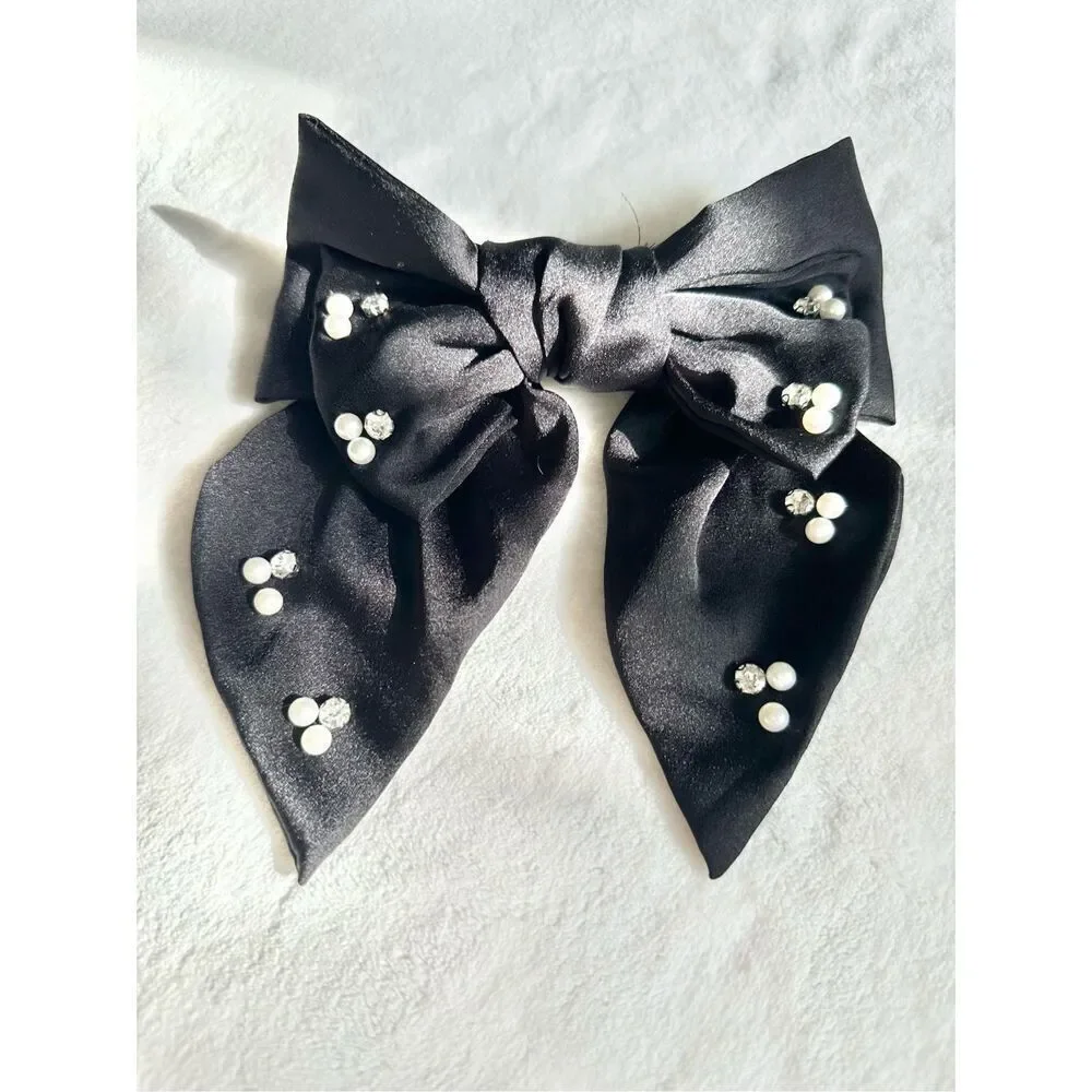 Black bow with rhinestone and pearl embellishment